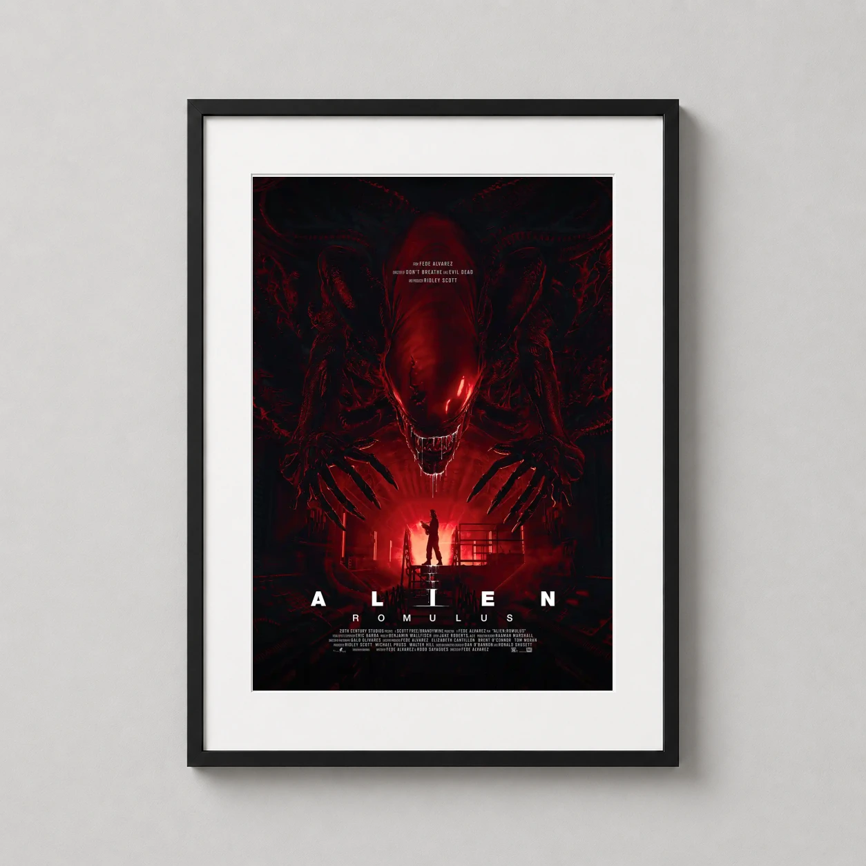 Alien Romulus — towering Xenomorph looms over a lone survivor in this deep crimson