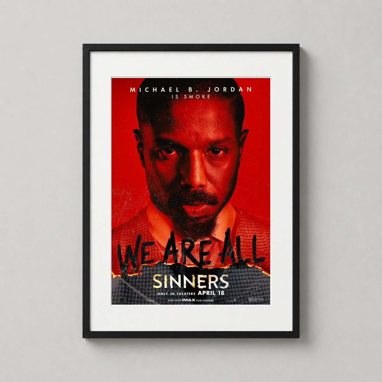 Michael B. Jordan Sinners — intense red-hued movie poster for Sinners featuring a close-up of