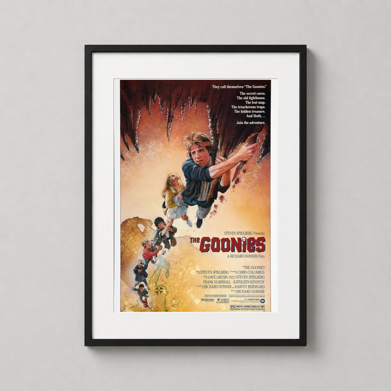 Room mockup of The Goonies 1985 Original Adventure Wall Art Movie Poster, displayed as framed wall art in a home theater setting as a portrait print.