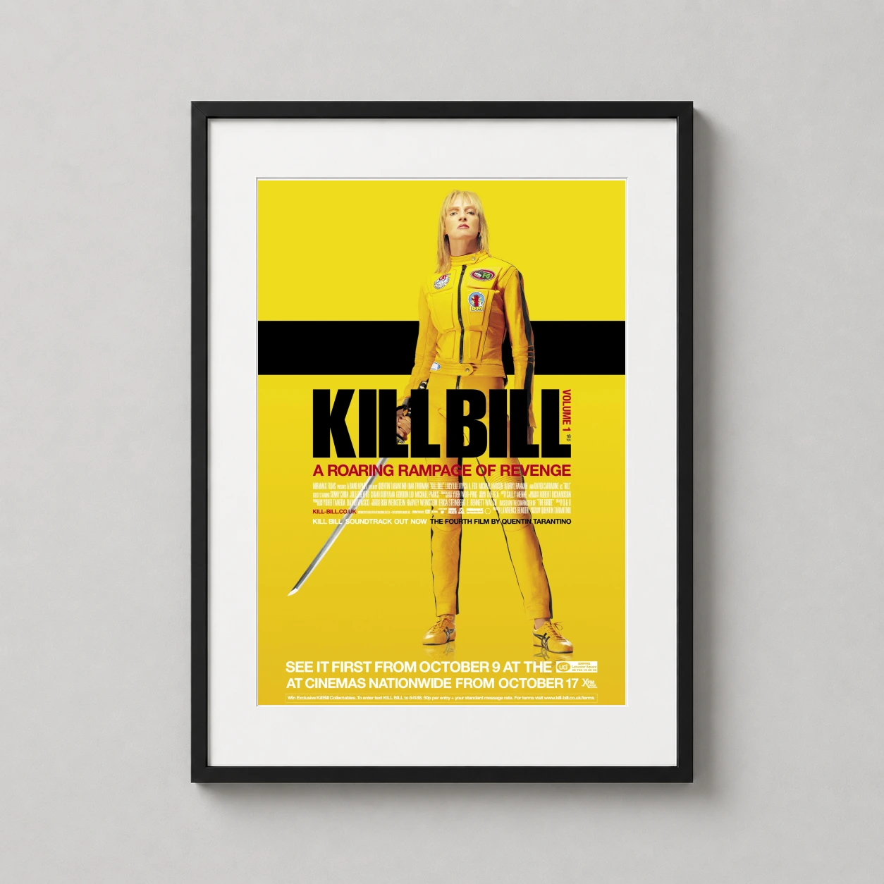 Room mockup of Kill Bill Yellow Tracksuit Uma Thurman Movie Poster, displayed as framed wall art in a home theater setting as a portrait print with yellow tones.
