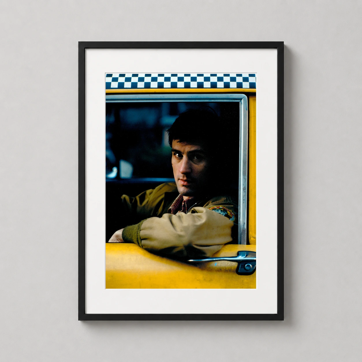 Room mockup of Taxi Driver Travis Bickle Cab Portrait Movie Poster, displayed as framed wall art in a home theater setting as a portrait print with black and white and yellow tones.