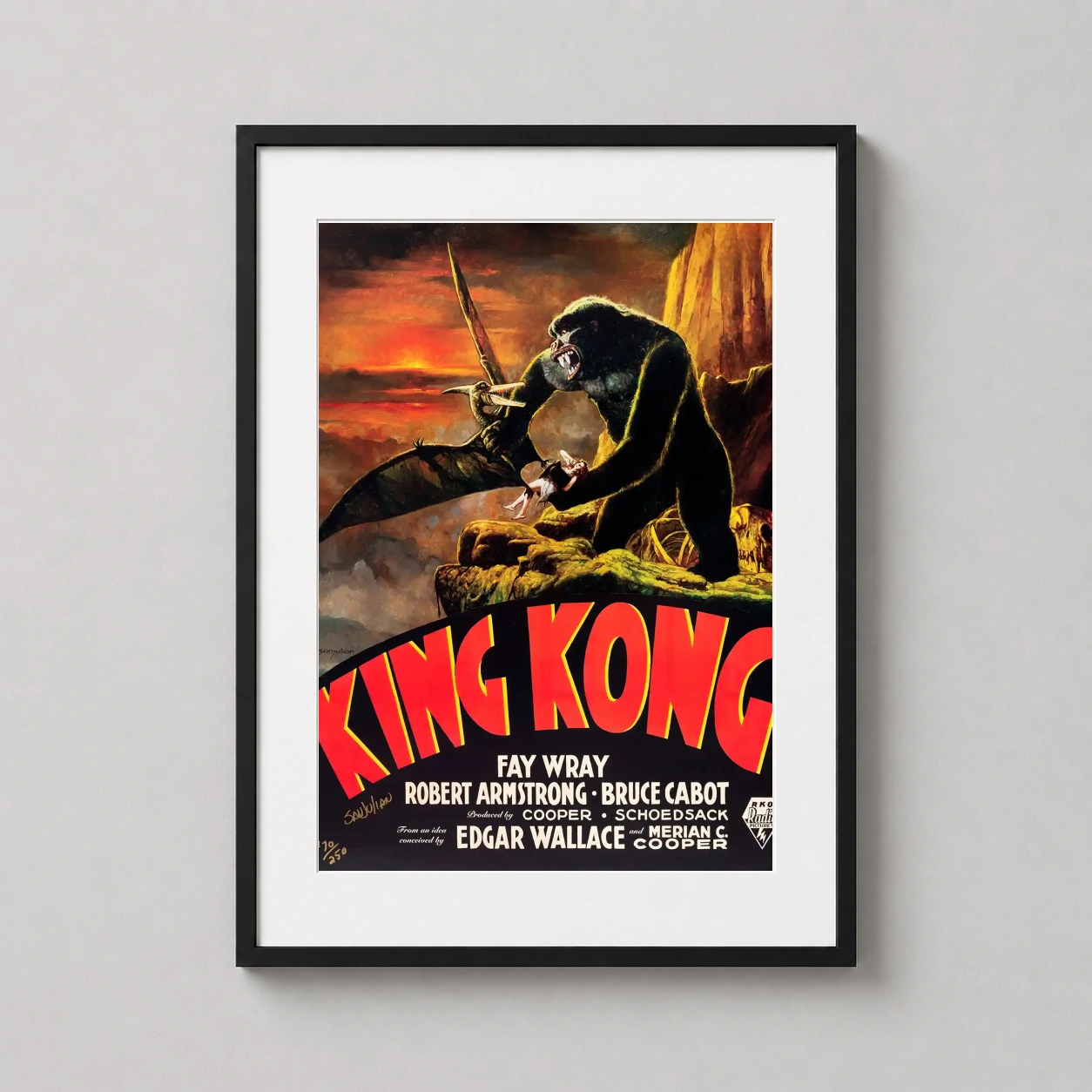 Room mockup of King Kong Sanjulian Vintage Battle Movie Poster, displayed as framed wall art in a home theater setting as a portrait print with yellow and red tones.