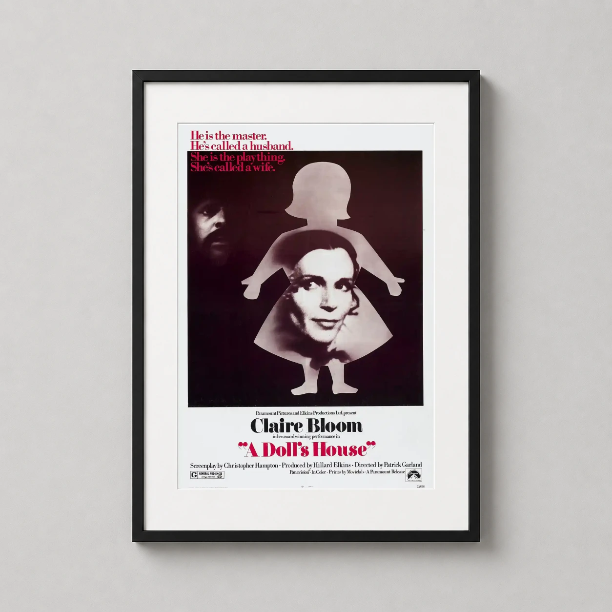 Room mockup of A Doll's House 1973 Movie Poster Claire Bloom Silhouette Print, displayed as framed wall art in a home theater setting as a portrait print with red tones.