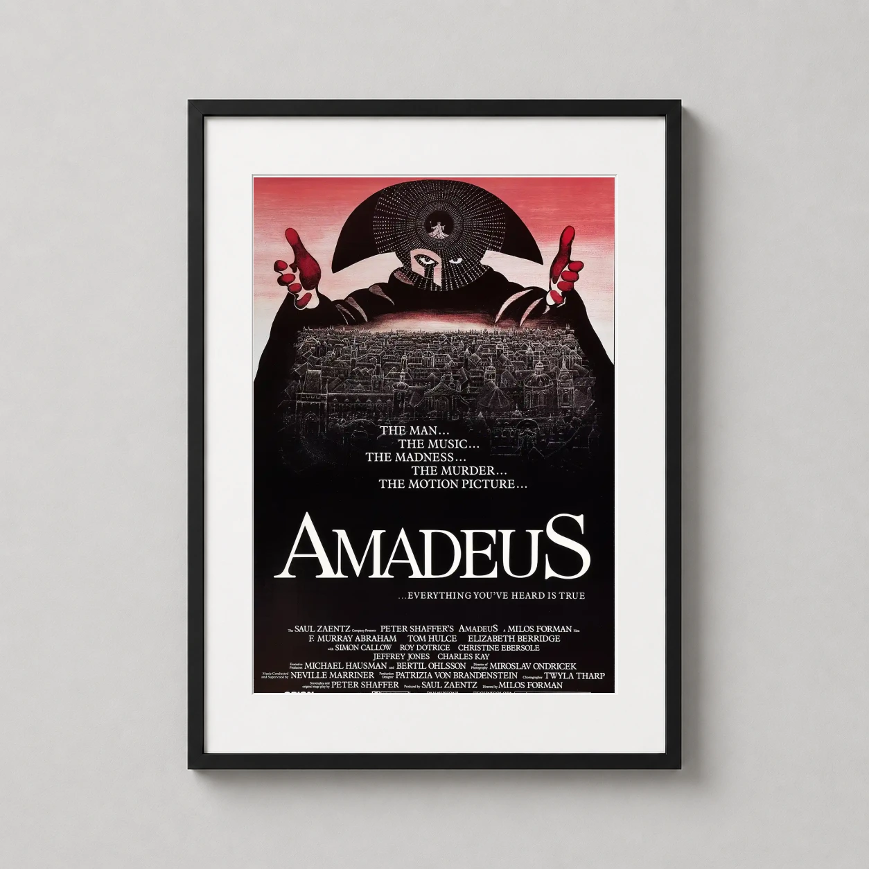Room mockup of Amadeus 1984 Original Salieri Mask Movie Poster, displayed as framed wall art in a home theater setting as a portrait print with red and black tones.