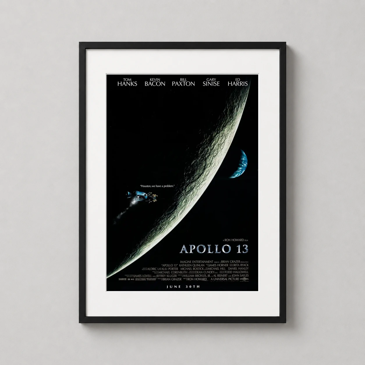 Room mockup of Apollo 13 1995 Ron Howard Space Drama Print Movie Poster, displayed as framed wall art in a home theater setting as a portrait print with blue tones.