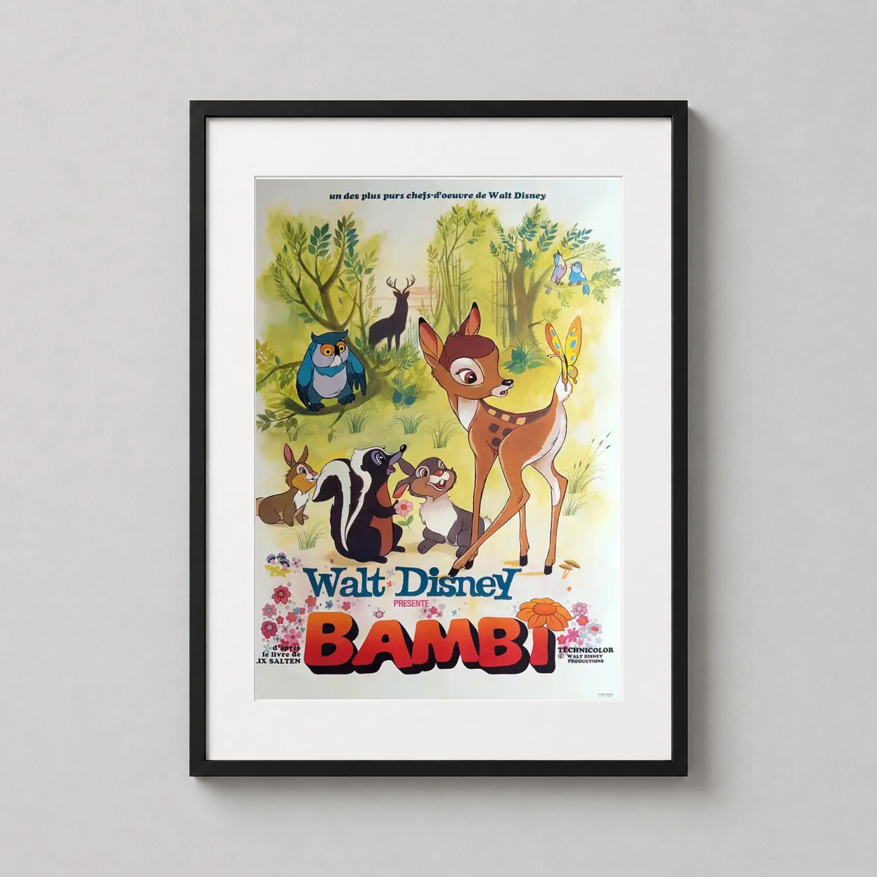 Room mockup of Bambi Walt Disney French Vintage Movie Poster, displayed as framed wall art in a home theater setting as a portrait print with gold tones.