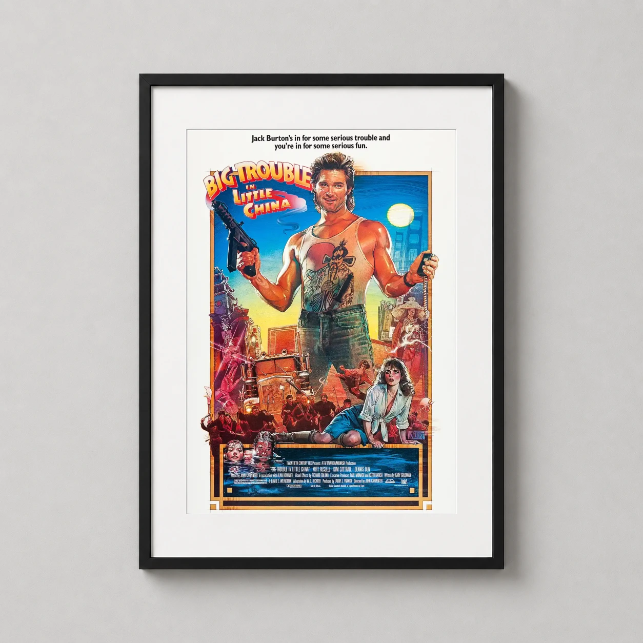 Room mockup of Big Trouble in Little China 1986 Retro Movie Poster, displayed as framed wall art in a home theater setting as a portrait print with red tones.