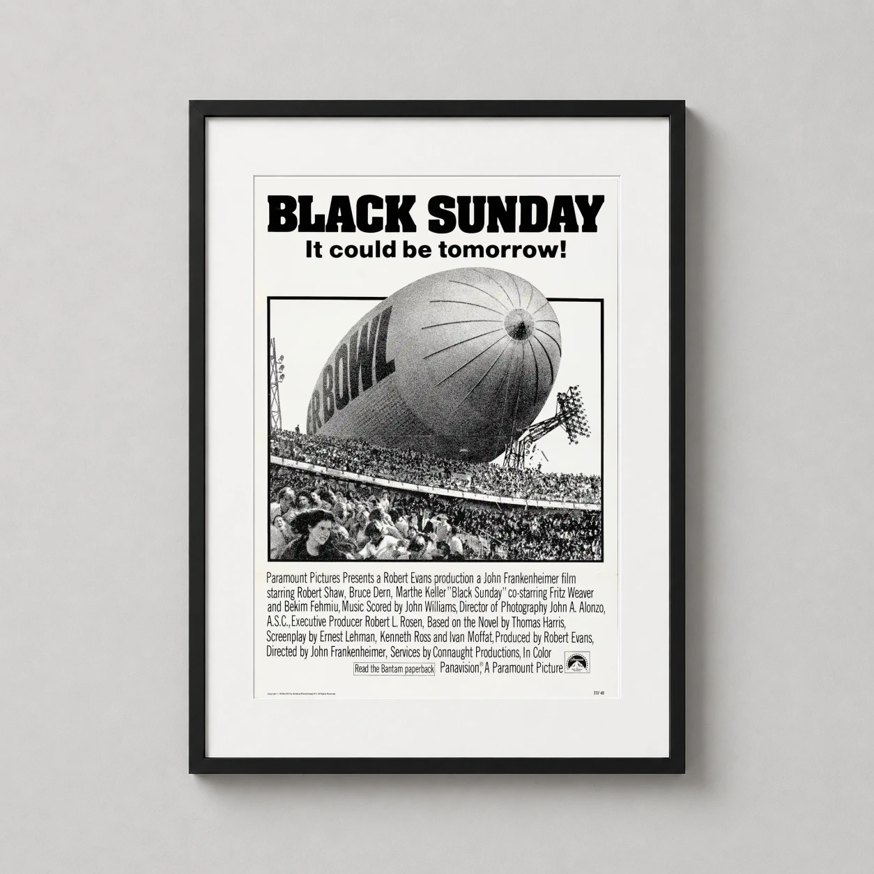 Room mockup of Black Sunday 1977 Movie, Vintage Blimp Disaster Movie Poster, displayed as framed wall art in a home theater setting as a portrait print with black and white tones.