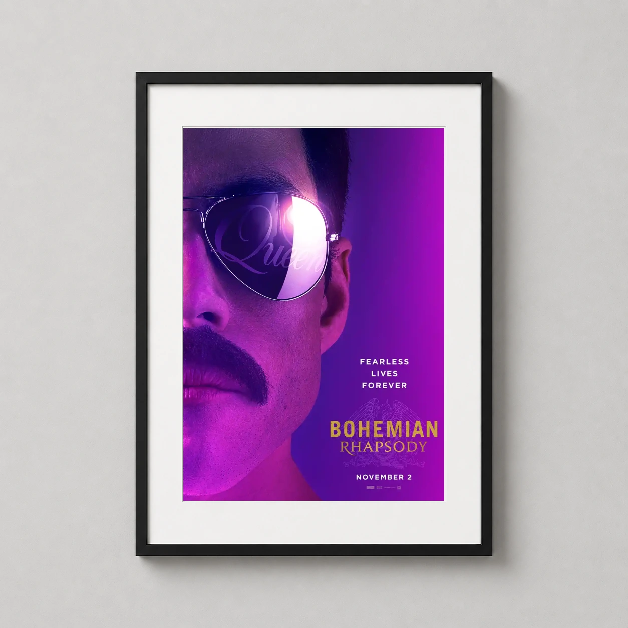 Room mockup of Bohemian Rhapsody Freddie Mercury Aviator Movie Poster, displayed as framed wall art in a home theater setting as a portrait print with gold and purple tones.