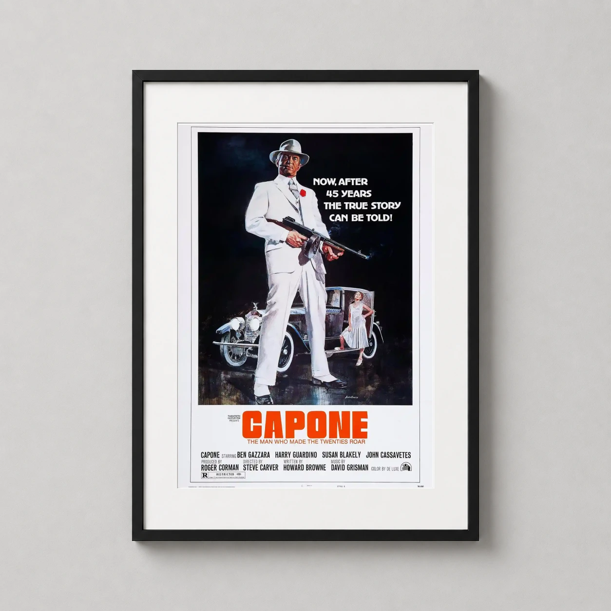 Room mockup of Capone 1975 Vintage Al Capone Crime Movie Poster, displayed as framed wall art in a home theater setting as a portrait print with red and white tones.