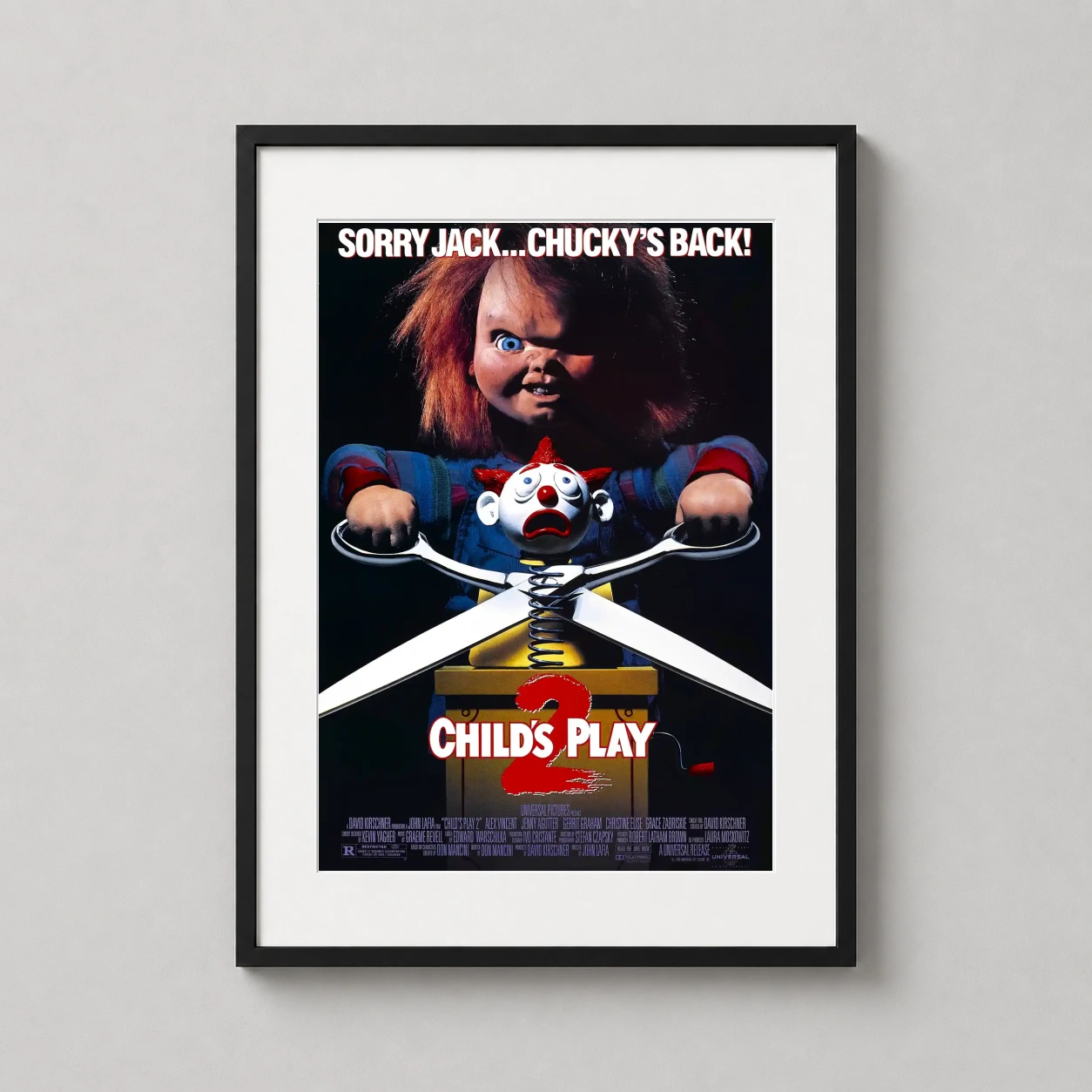 Room mockup of Child's Play 2 1990 Chucky Horror Movie Poster, displayed as framed wall art in a home theater setting as a portrait print with blue and red tones.