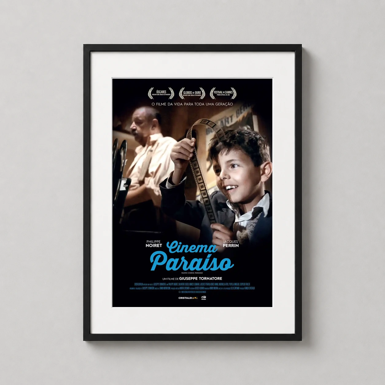 Cinema Paradiso — featuring young Salvatore holding a film strip alongside Alfredo in the