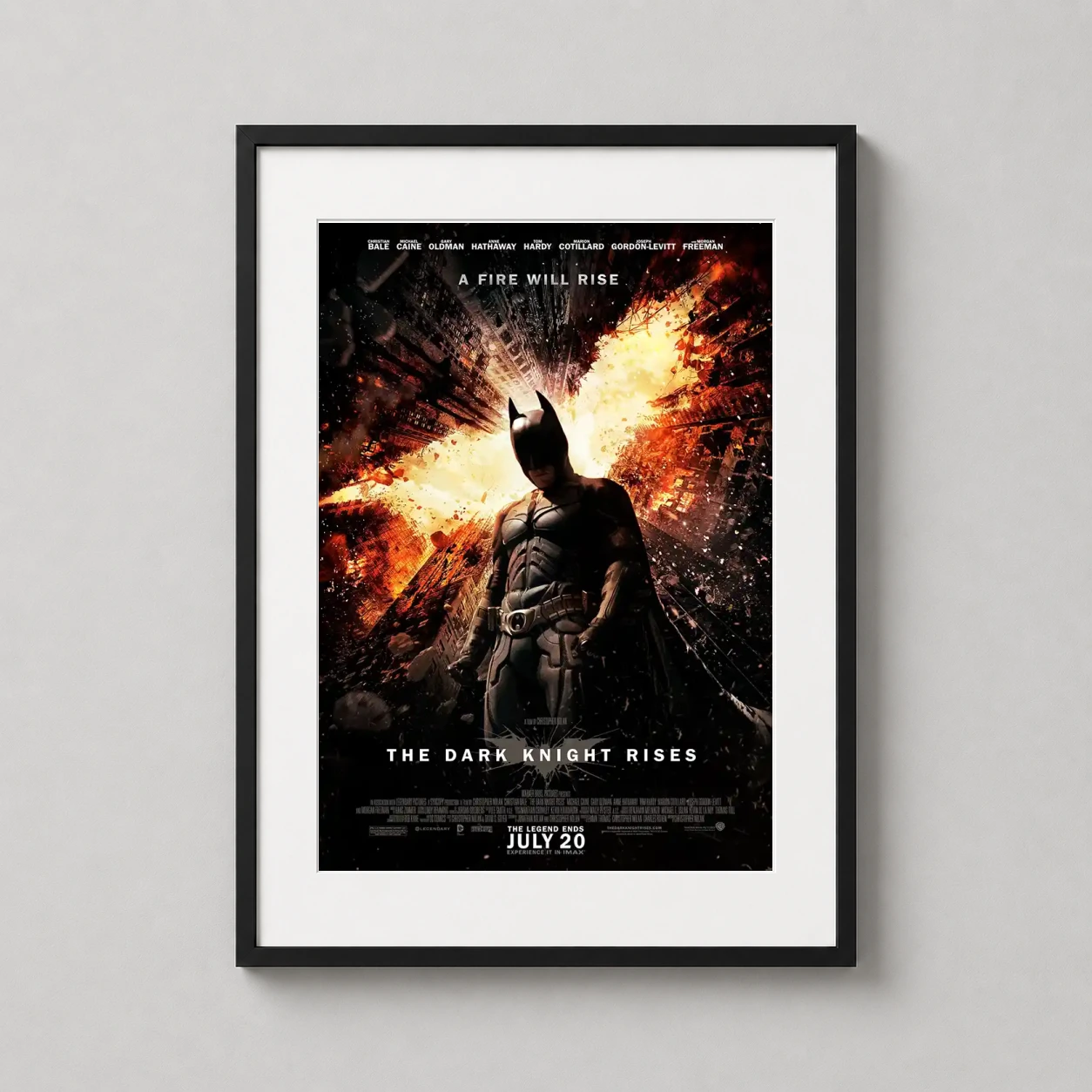 Room mockup of The Dark Knight Rises Batman Amidst Fiery Gotham Movie Poster, displayed as framed wall art in a home theater setting as a portrait print with orange tones.