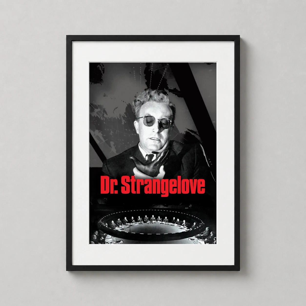 Room mockup of Dr. Strangelove Stanley Kubrick Film Poster, Classic War Satire, displayed as framed wall art in a home theater setting as a portrait print with red tones.