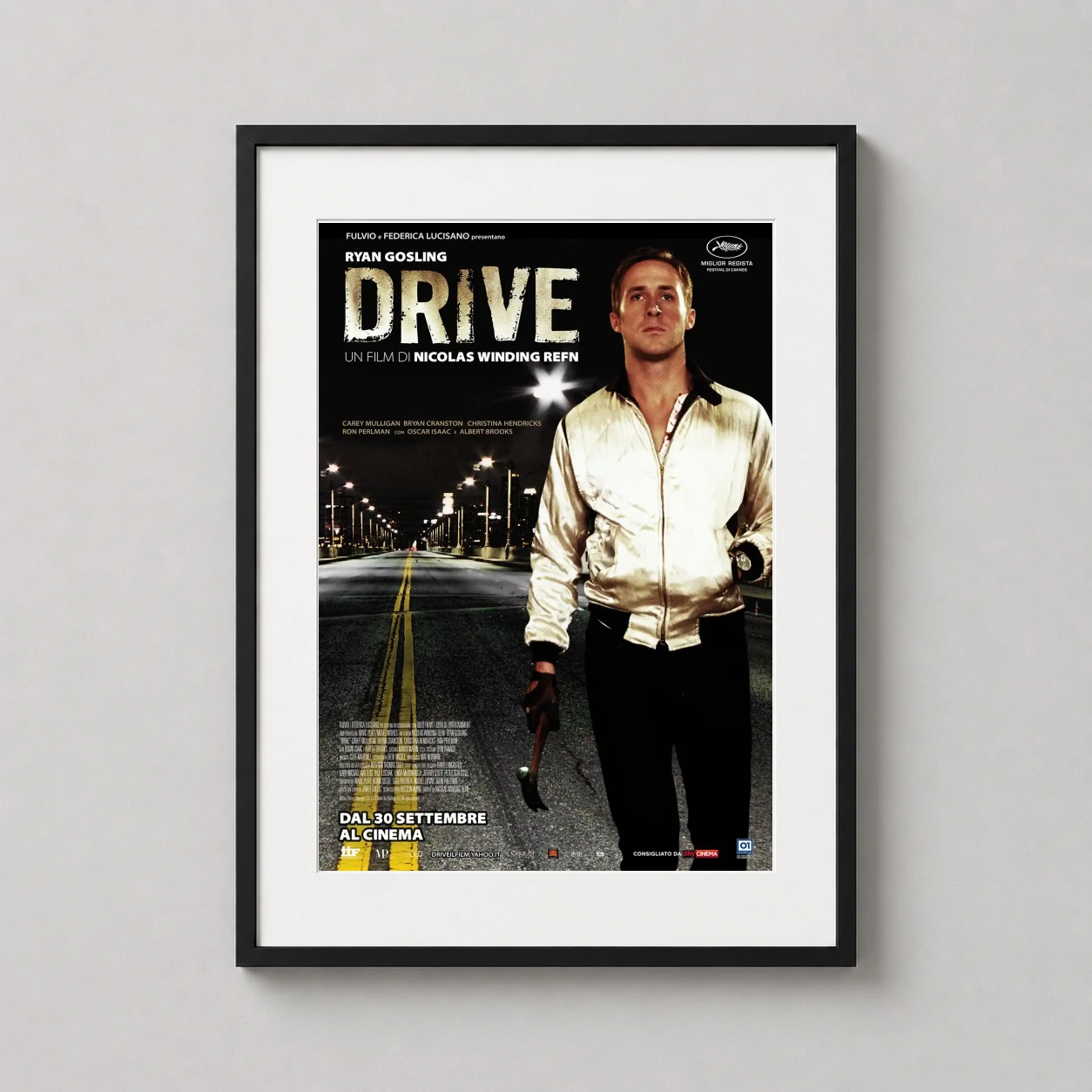 Room mockup of Drive 2011 Ryan Gosling Night Street Movie Poster, displayed as framed wall art in a home theater setting as a portrait print with yellow and white tones.