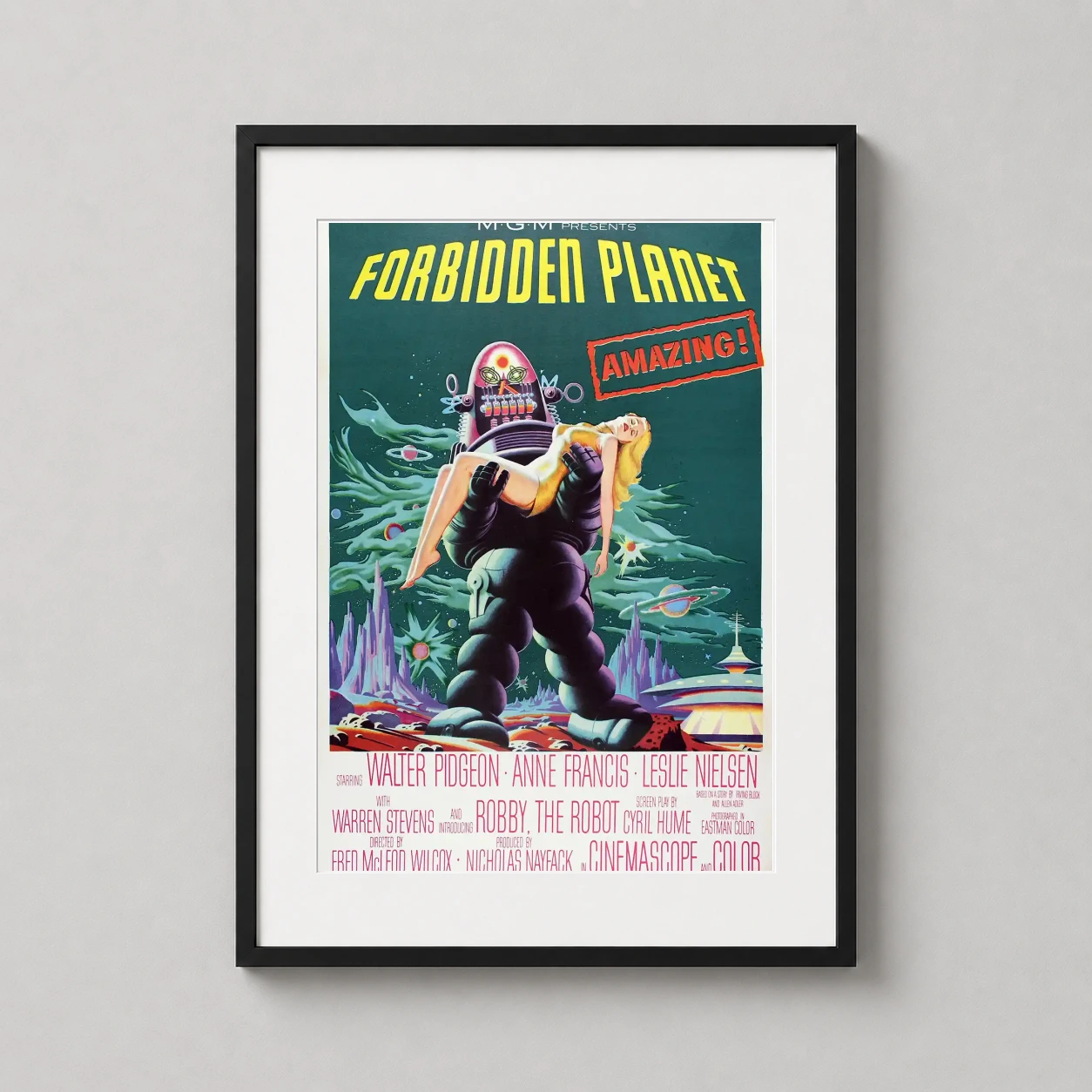 Room mockup of Forbidden Planet 1956 Retro Sci-Fi Movie Poster, displayed as framed wall art in a home theater setting as a portrait print with yellow and red tones.