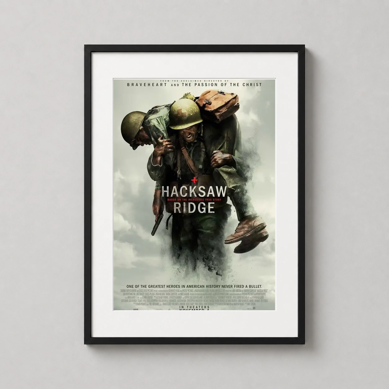 Hacksaw Ridge — movie poster featuring Desmond Doss carrying a wounded soldier amidst