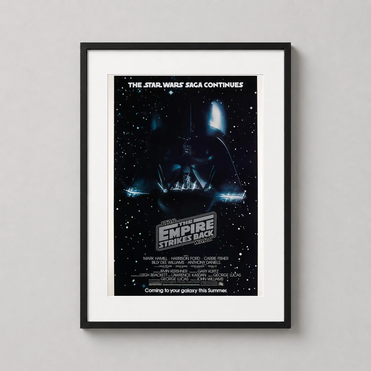 Empire Strikes Back — this vintage-style movie poster features Darth Vader's looming