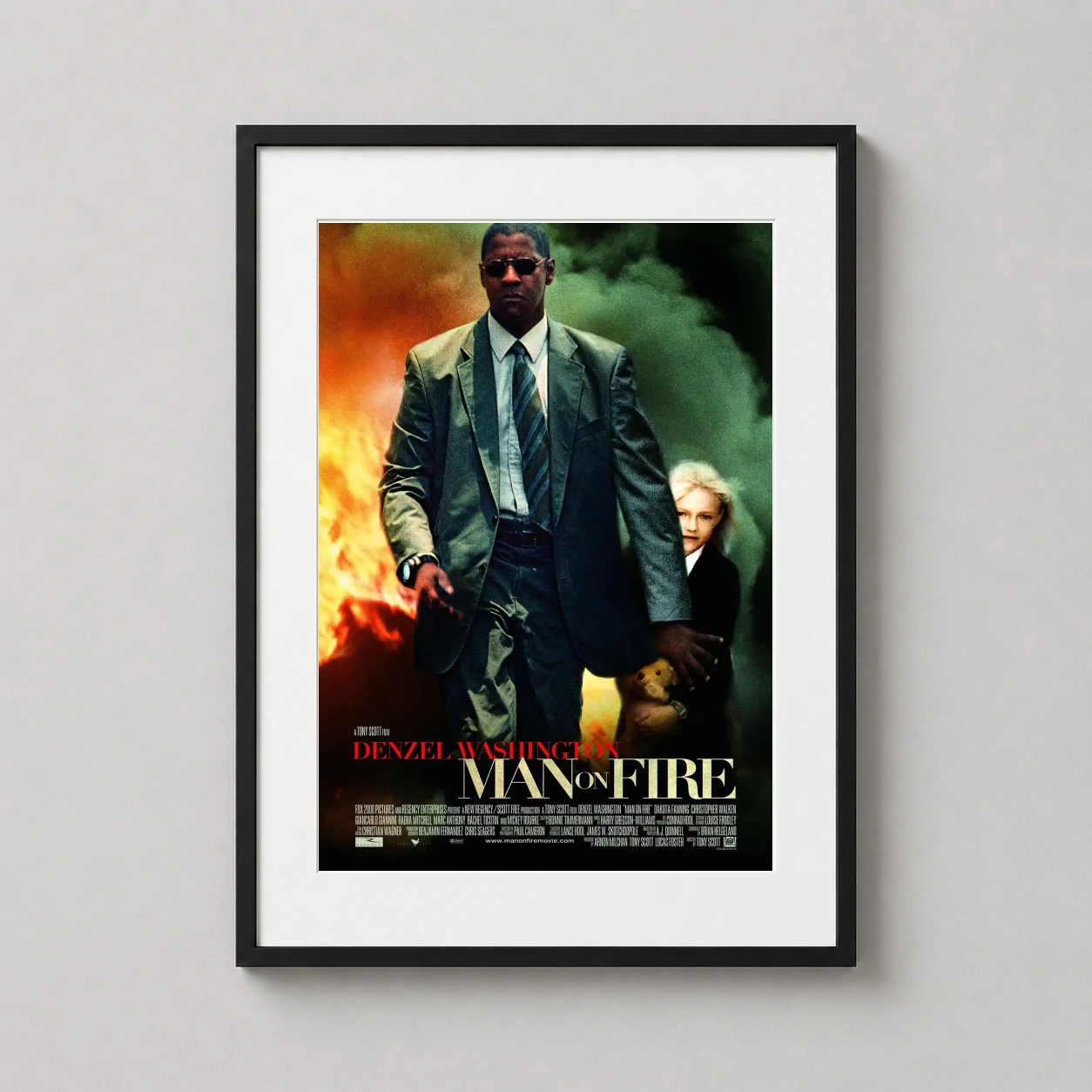 Man Fire — denzel Washington stands resolute against a backdrop of flames and