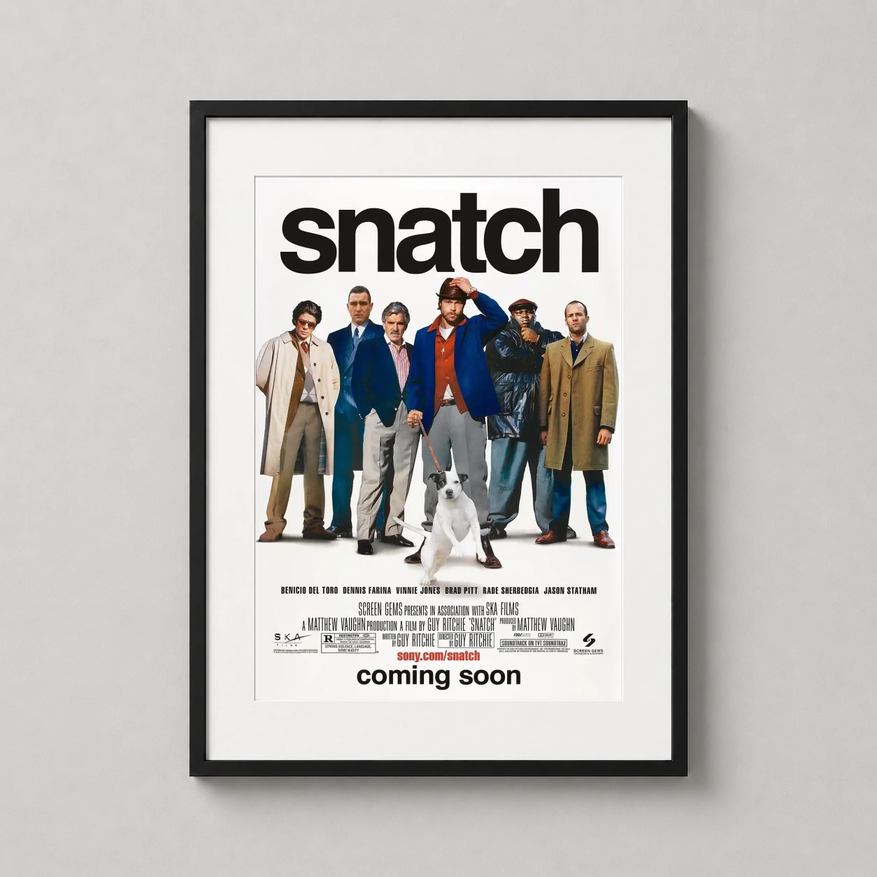 Room mockup of Snatch Ensemble Cast Guy Ritchie Movie Poster, displayed as framed wall art in a home theater setting as a portrait print with white tones.