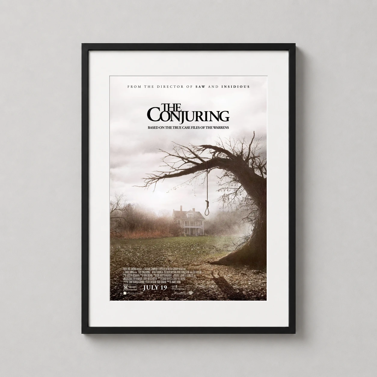 Conjuring — gnarled, leafless tree with a hanging noose overlooks a misty farmhouse