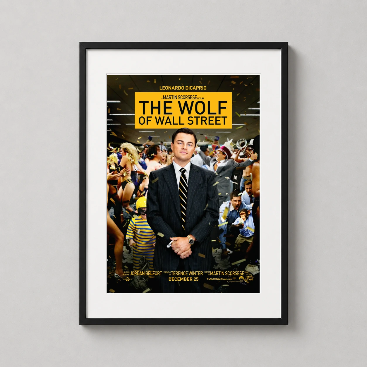 Room mockup of The Wolf of Wall Street (2013) Scorsese Movie Poster, displayed as framed wall art in a home theater setting as a portrait print with yellow and gold tones.