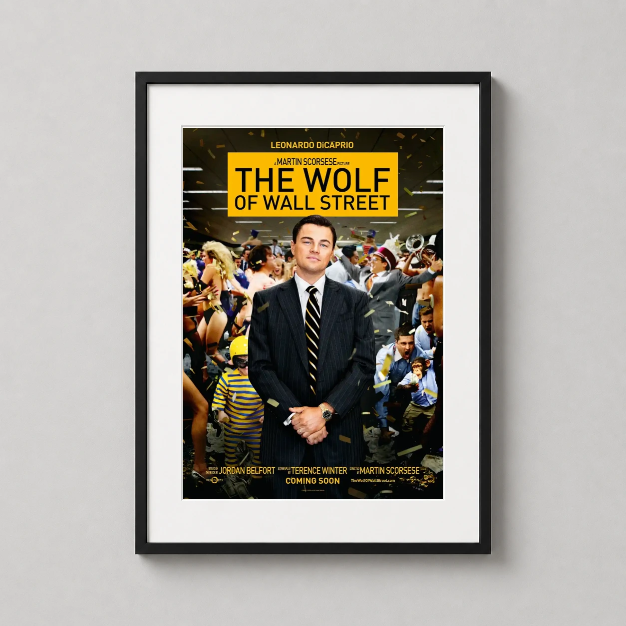 Room mockup of The Wolf of Wall Street Leonardo DiCaprio Movie Poster, displayed as framed wall art in a home theater setting as a portrait print with yellow and gold tones.