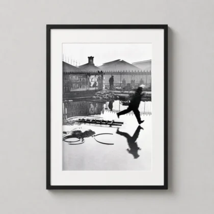 Henri Cartier-bresson Behind Gare — grainy black and white photography print capturing a man leaping over a