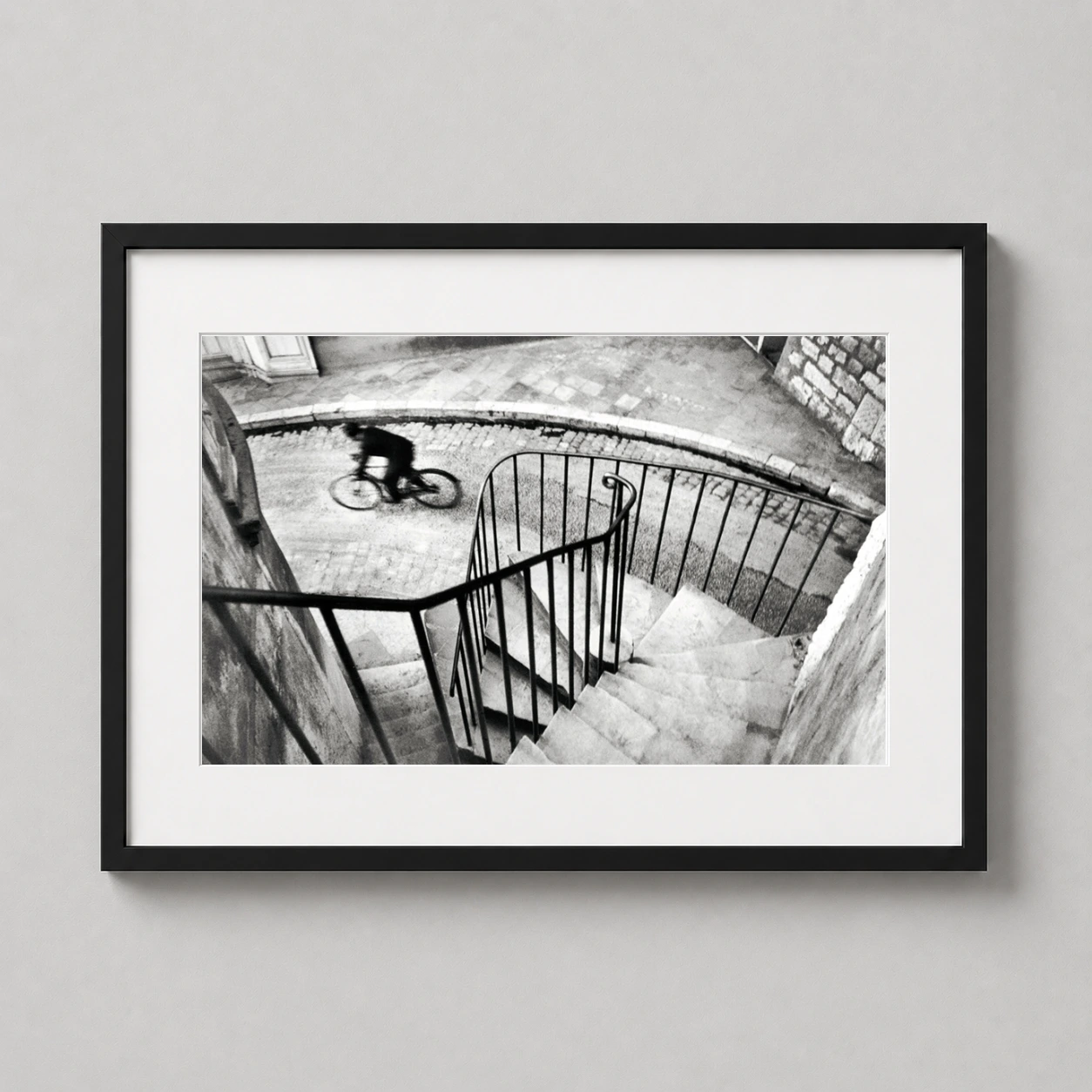 Henri Cartier-bresson Hyères France — grainy black and white photograph captures a blurred cyclist rushing