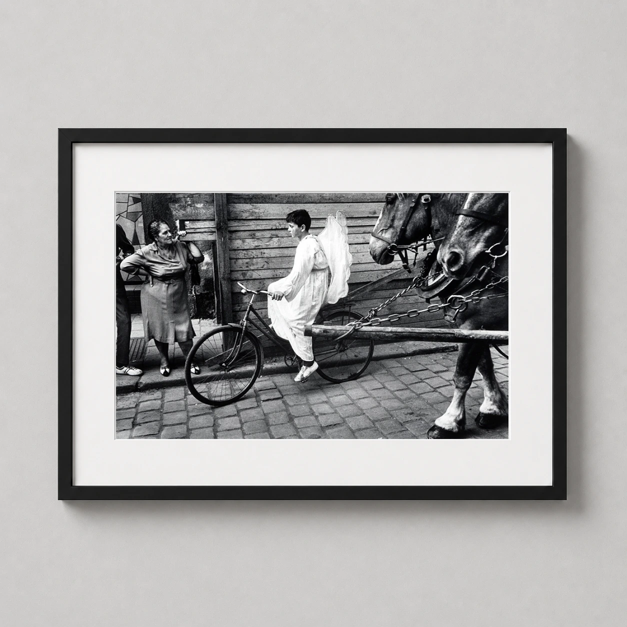 Josef Koudelka Angel Bicycle — surreal black and white fine art photograph capturing a boy in an angel