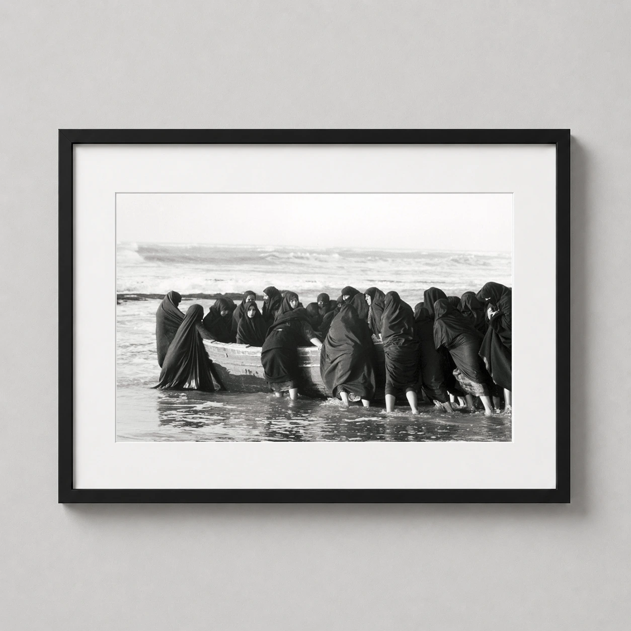 Shirin Neshat Untitled Rapture Photo — group of women in traditional black chadors gather at the water's edge