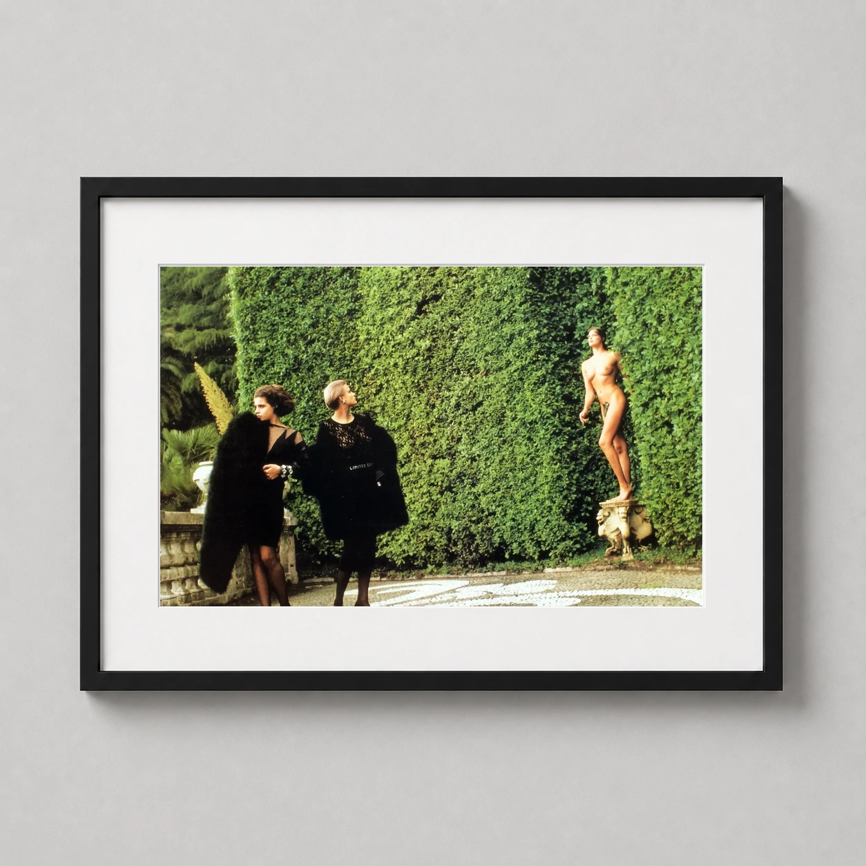 Helmut Newton Another World — high-fashion scene by Helmut Newton featuring models in black couture