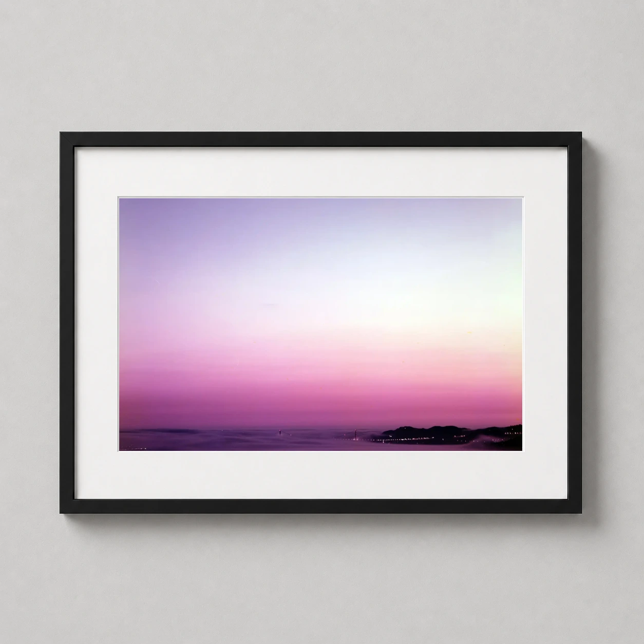 Room mockup of Richard Misrach Golden Gate Bridge 1998 California Landscape Print Photography Print, displayed as framed wall art in a office setting as a landscape print with gold, orange, and pink tones.