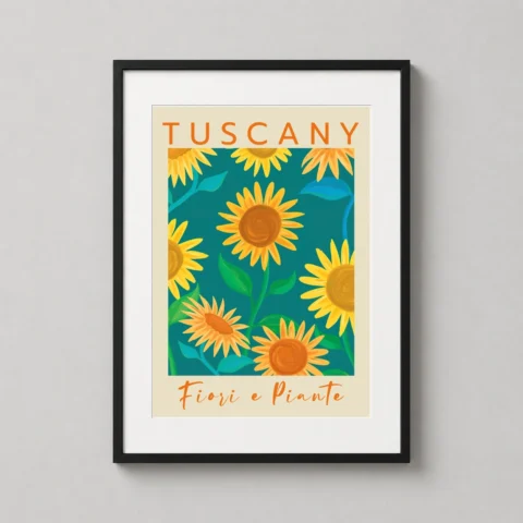 A framed Tuscany sunflowers art print hangs in a modern dining room setting above a light wood table.