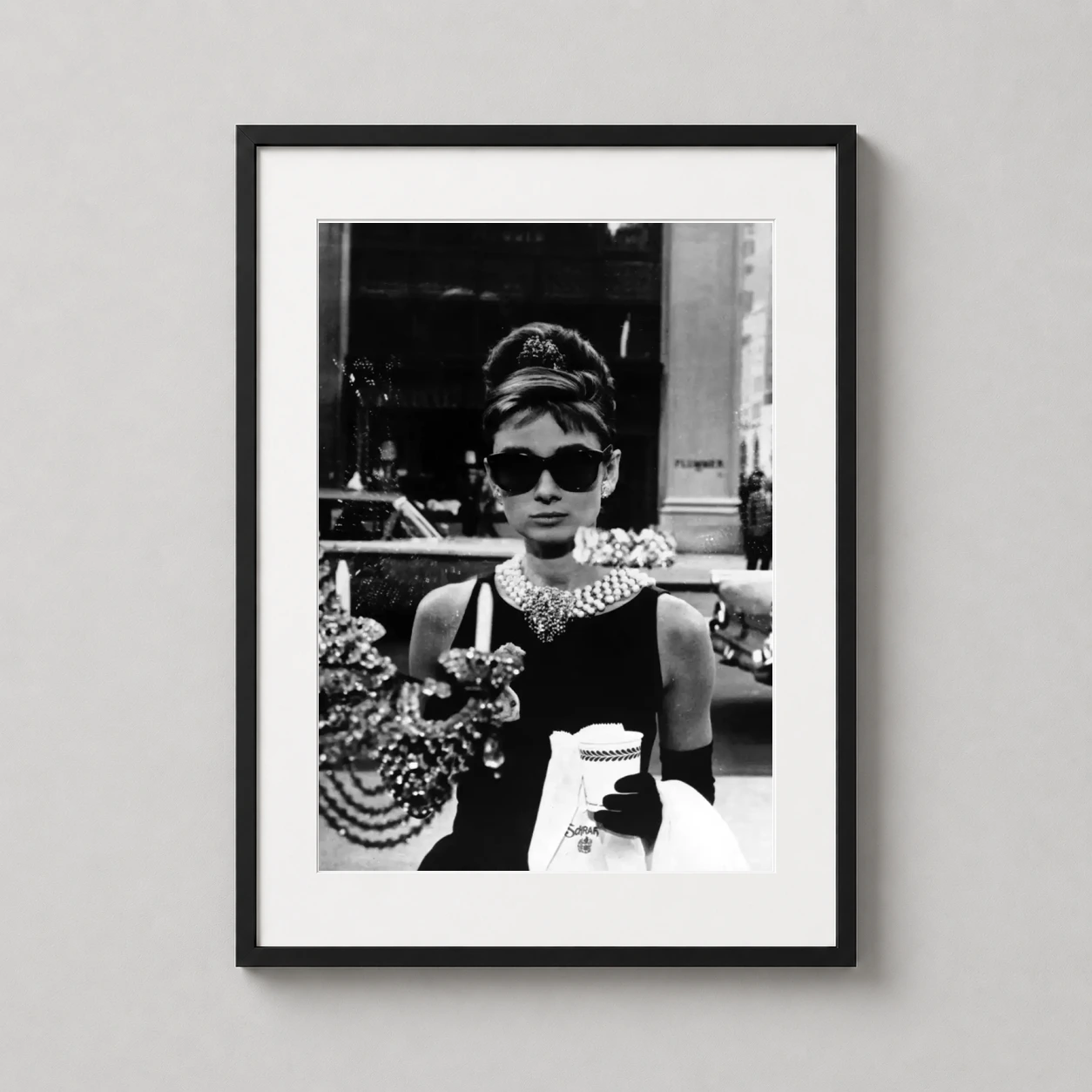 Audrey Hepburn Breakfast Tiffany's — audrey Hepburn stands before the Tiffany & Co. window in her black