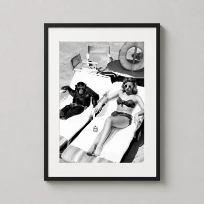Chimpanzee and a Woman Sunbathing – Vintage Funny Black-and-White black-and-white photography print by MerchFuse