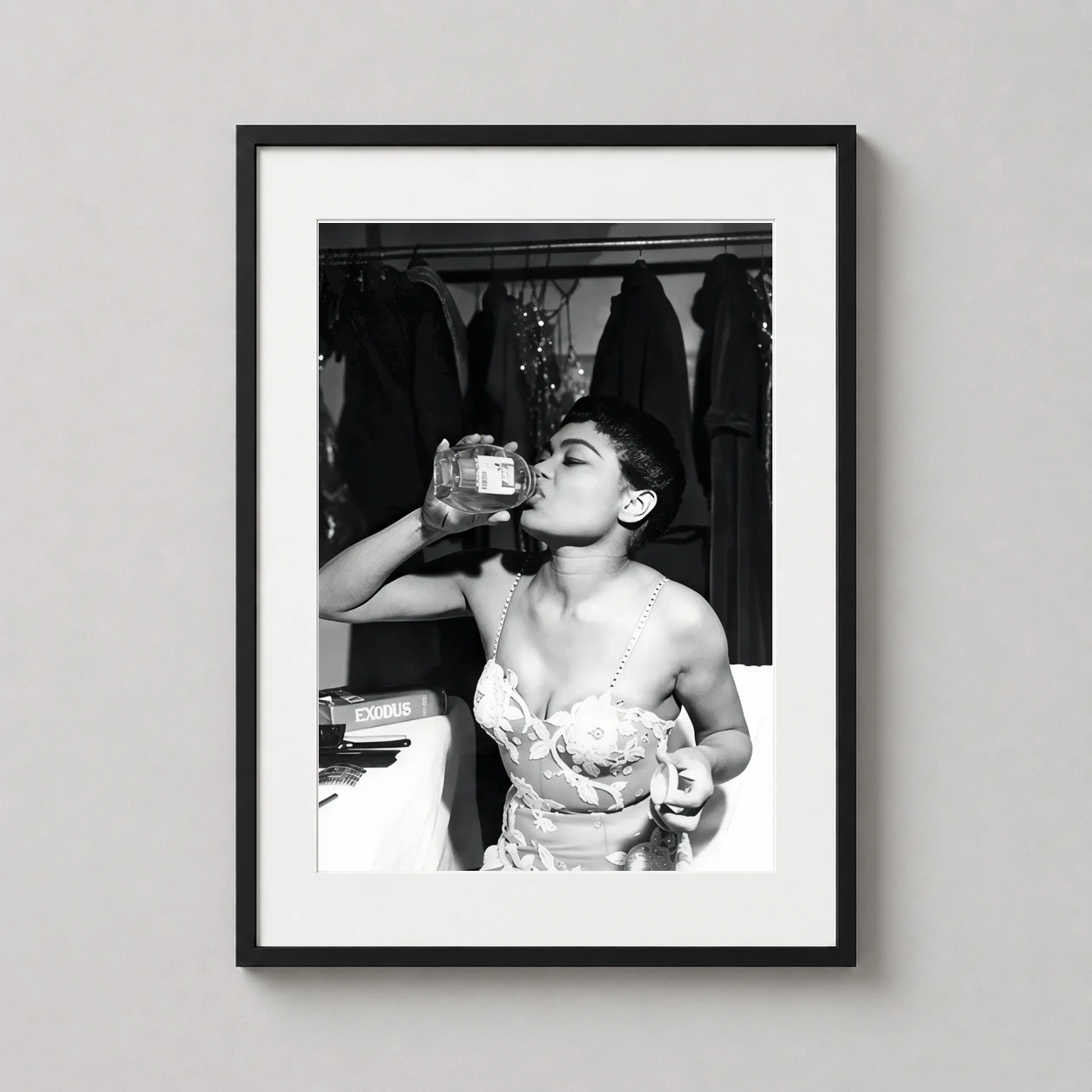 Eartha Kitt Drinking Honey — vintage black and white photograph of Eartha Kitt backstage, wearing a