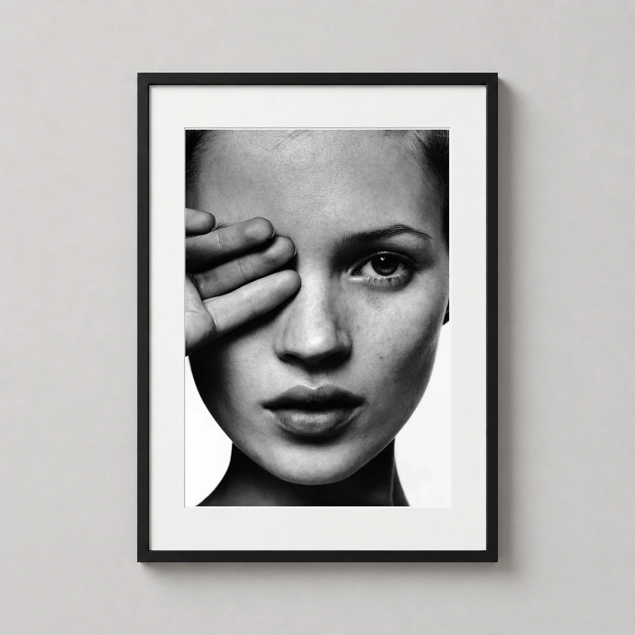 Kate Moss Blind Eye — high-contrast black and white close-up portrait of Kate Moss covering