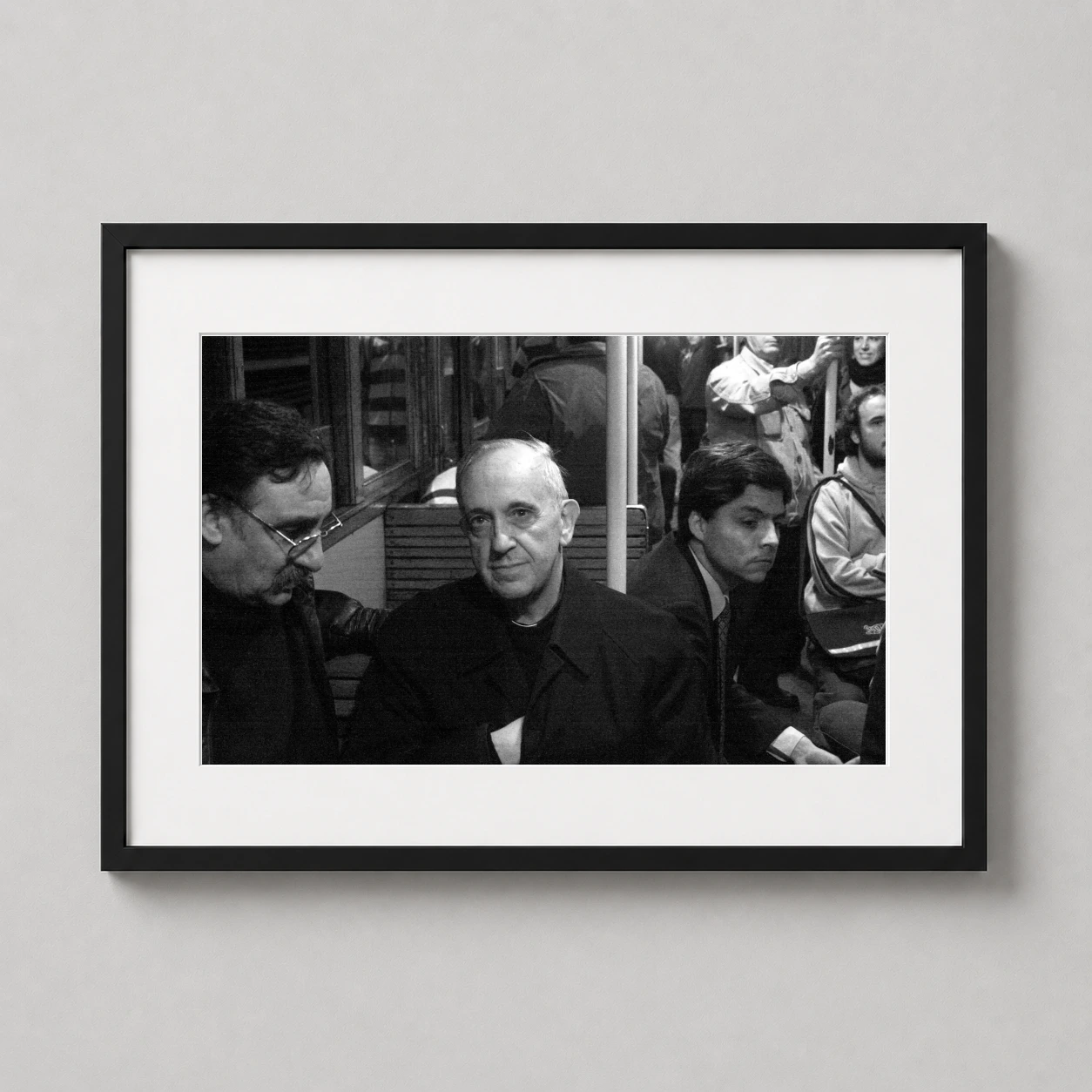 Pope Francis Public Transport Photo — candid black and white photograph of Pope Francis riding a public bus