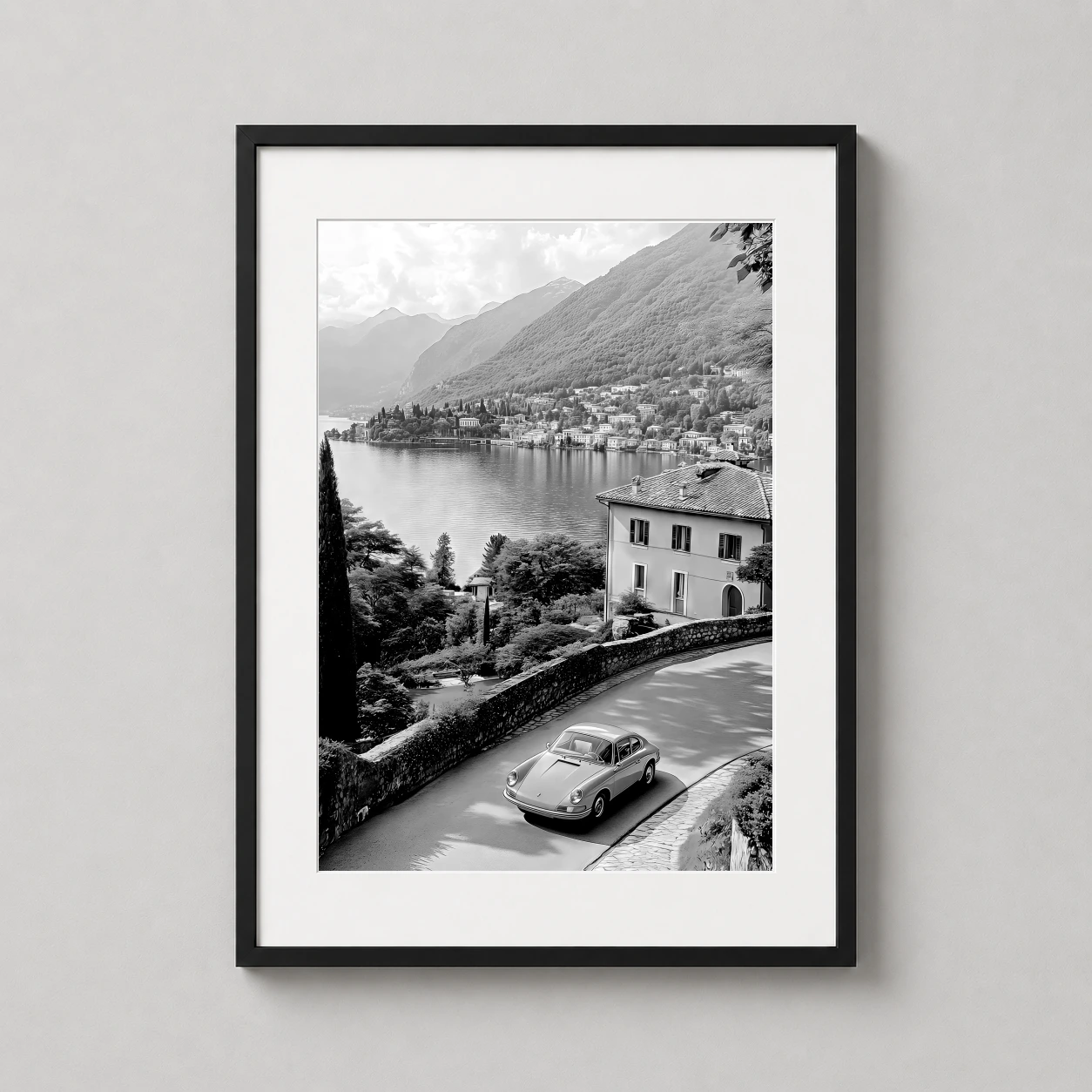 Porsche 911 Lake Como — classic Porsche 911 navigates a winding coastal road overlooking the