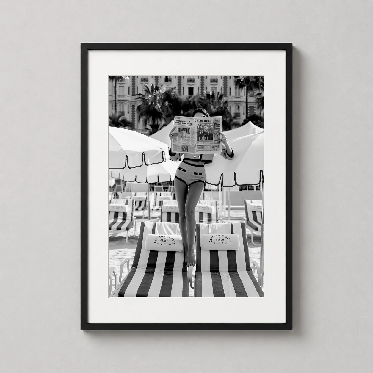 Woman Reading Newspaper Carlton Photo — sophisticated black and white photograph of a woman reading a newspaper