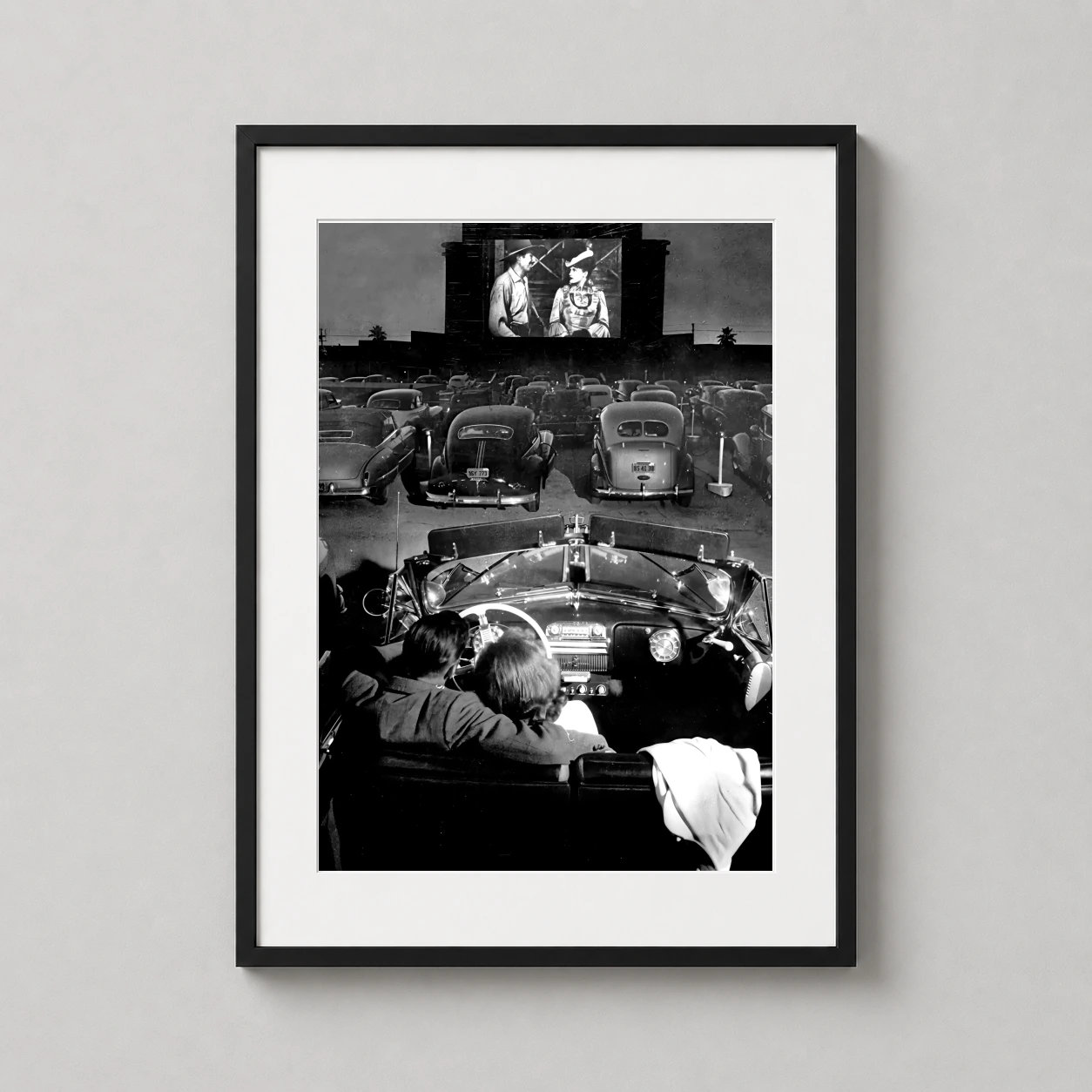 Room mockup of Drive-In Cinema Vintage Movie Night Black and White Movie Poster, displayed as framed wall art in a home theater setting as a portrait print with black and white tones.
