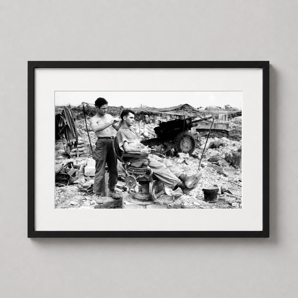 Room mockup of Vintage 1945 Army Barber Photography, WW2 Soldier Photography Print, displayed as framed wall art in a office setting as a landscape print with black and white tones.