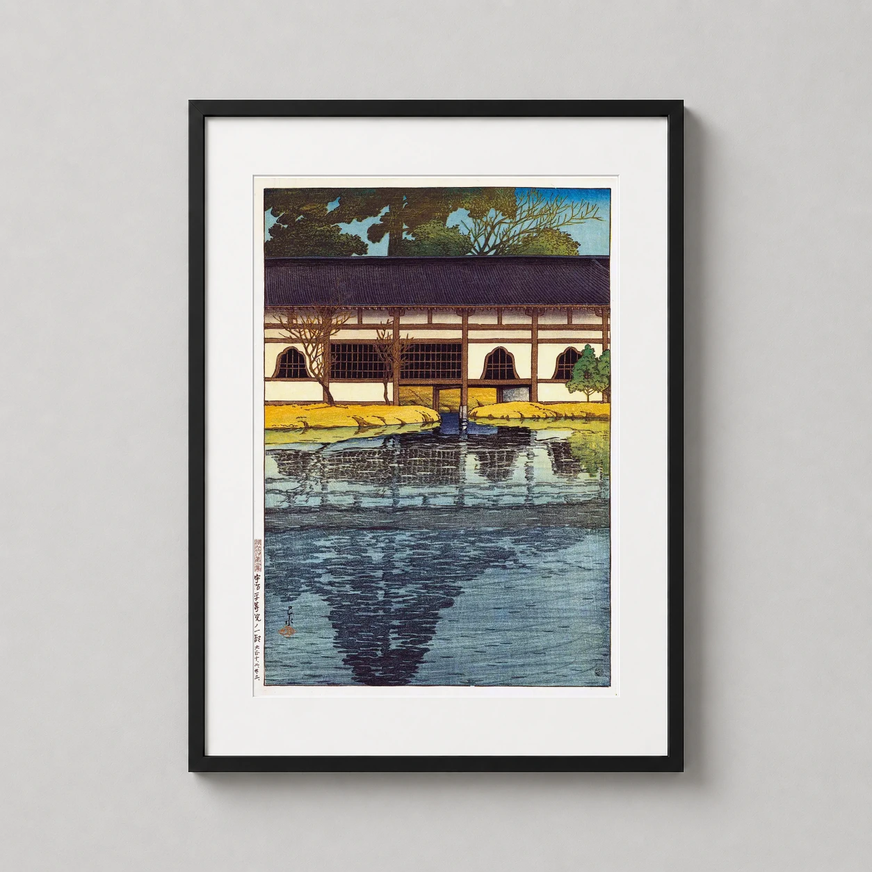 Room mockup of Byodo Temple Uji, Japanese Woodblock Style Fine Art Print, displayed as framed wall art in a bedroom setting as a portrait print with blue and gold tones.