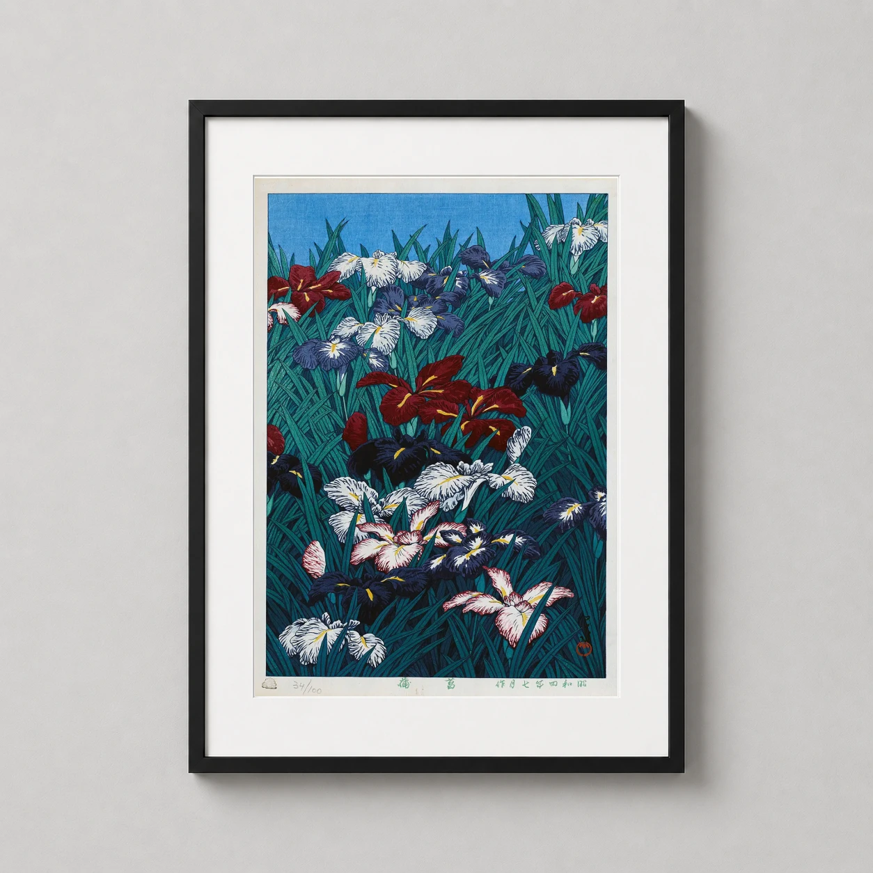 Room mockup of Ayame Iris, 1929 by Kawase Hasui Japanese Woodblock Art Print, displayed as framed wall art in a bedroom setting as a portrait print with blue, green, and red tones.
