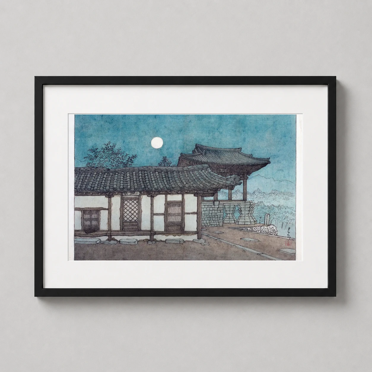 Room mockup of Evening Moon Over Traditional Japanese Temple Woodblock Art Print, displayed as framed wall art in a bedroom setting as a landscape print with blue and teal tones.