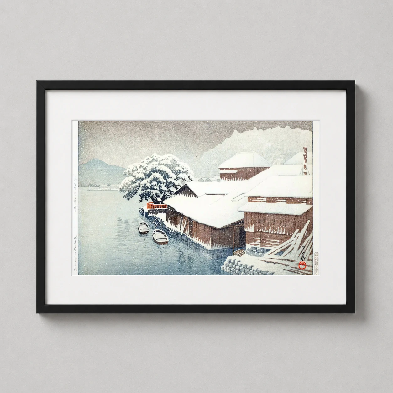 Room mockup of Evening Snow at Ishinomaki by Hasui Kawase 1935 Art Print, displayed as framed wall art in a bedroom setting as a landscape print with blue tones.