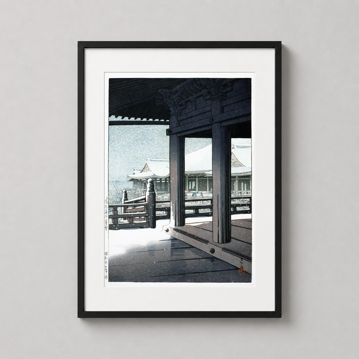 Room mockup of Evening Snow at Kiyomizu Temple, Kyoto Japanese Art Print, displayed as framed wall art in a bedroom setting as a portrait print with blue tones.