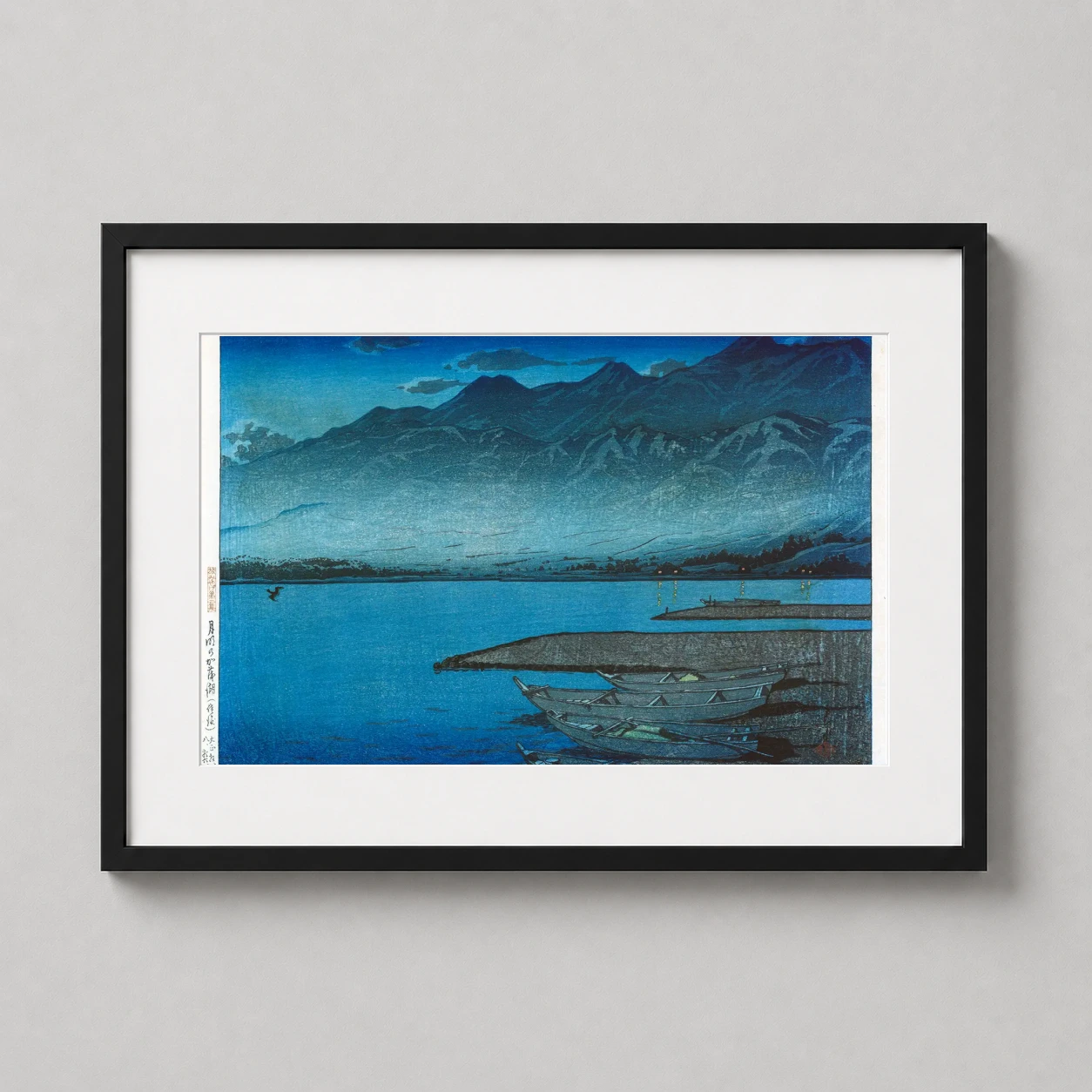 Room mockup of Classic Sado Island Woodblock, Moonlit Kamoko Wall Art Print, displayed as framed wall art in a bedroom setting as a landscape print with blue and teal tones.