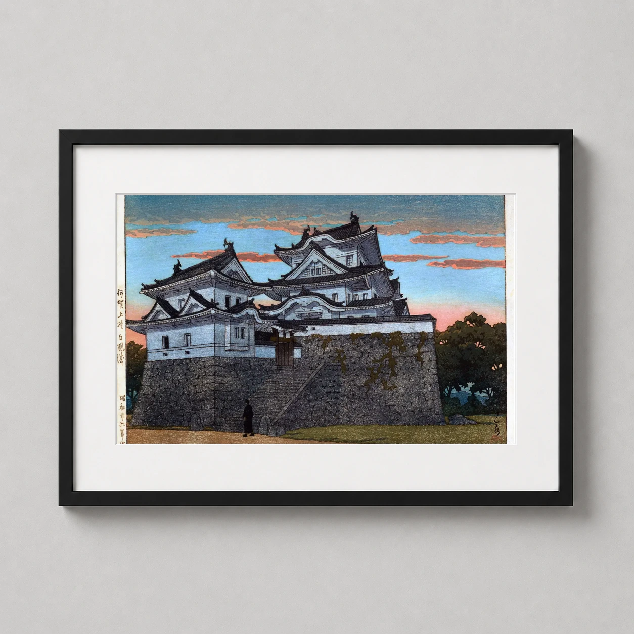 Room mockup of Iga Ueno Castle Japanese Woodblock Art Print, displayed as framed wall art in a bedroom setting as a landscape print with blue tones.